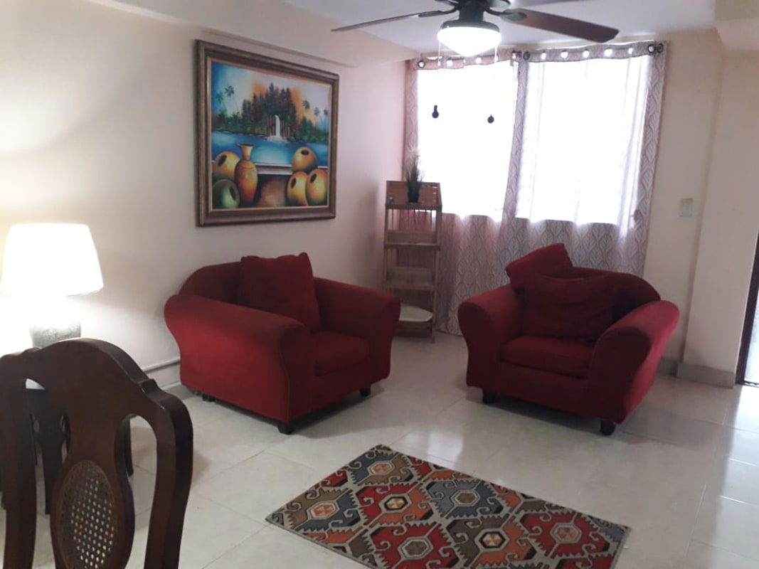 Open plan living and dining room with ceramic floors in family home Betania Panama