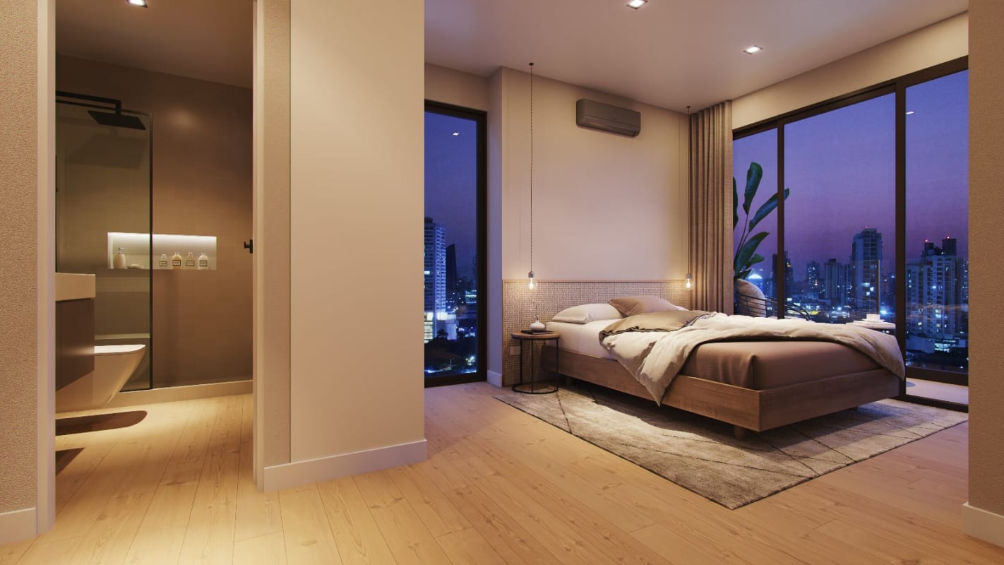 Bedroom with floor to ceiling windows and balcony face Panama City skyline in PH HUB Condo