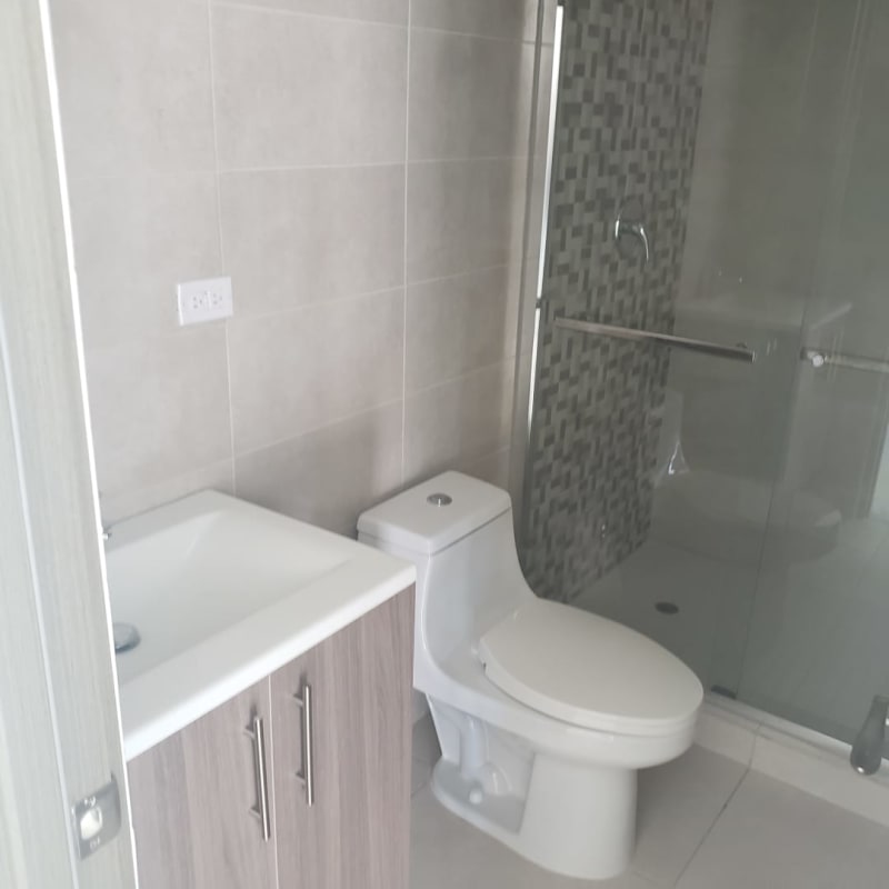 Modern open kitchen in new apartment with quartz countertop and tile backsplash in Panama City