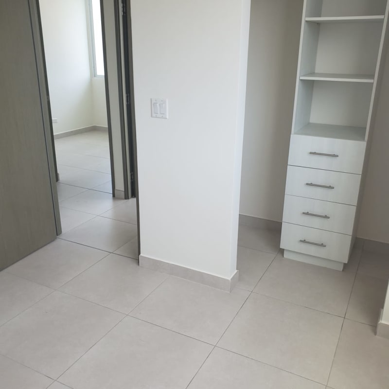 Spacious bedroom in new apartment Vista Hermosa with large window showing city skyline