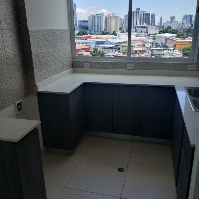 Kitchen island countertop and skyline city window view in new apartment project PH Vista Hermosa Panama