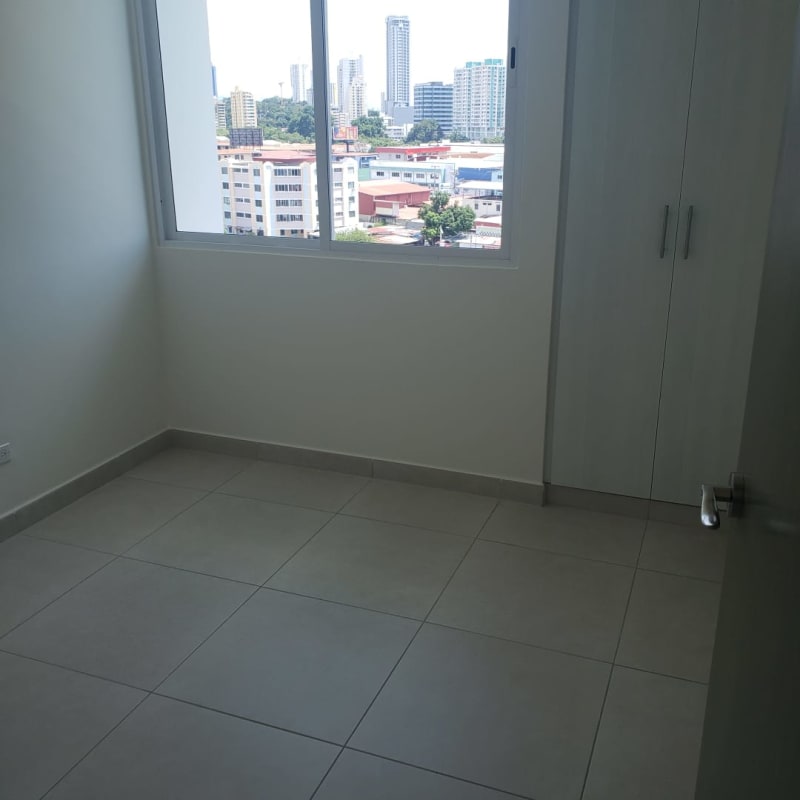 Modern new apartment bedroom with tile flooring and space for built-in closets in Vista Hermosa