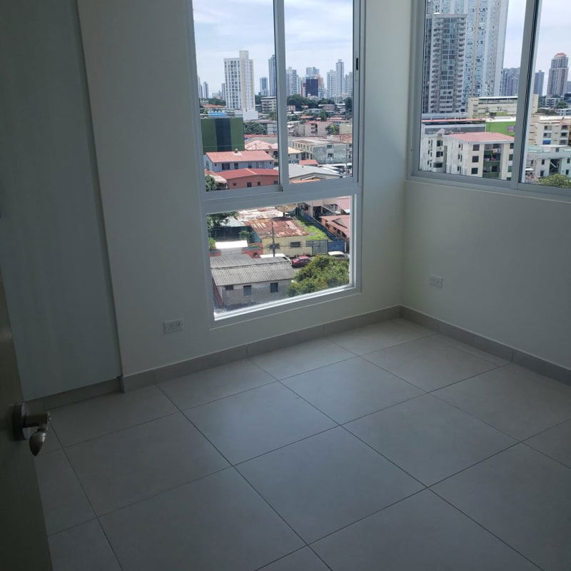 Bedroom with large windows and city skyline view at PH Vista Hermosa Panama City