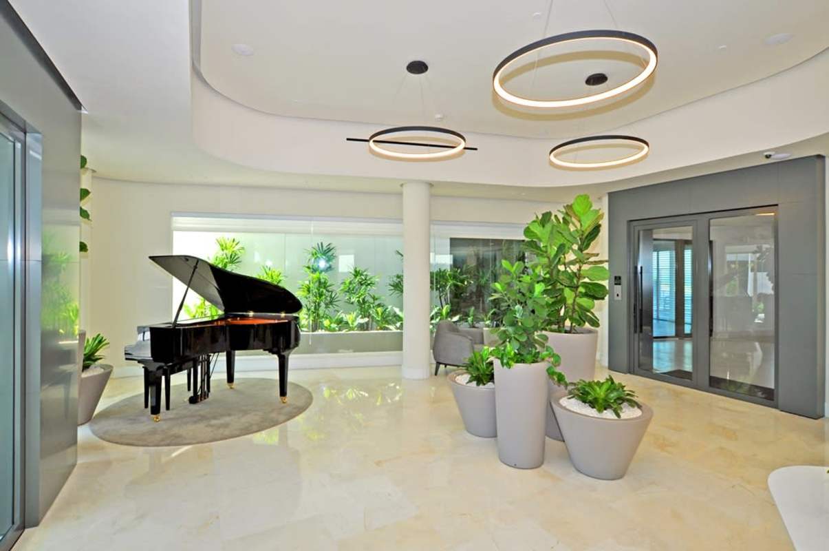 Spacious living and dining room with ocean views through floor-to-ceiling windows in PH Seascape Ocean Reef Punta Pacifica