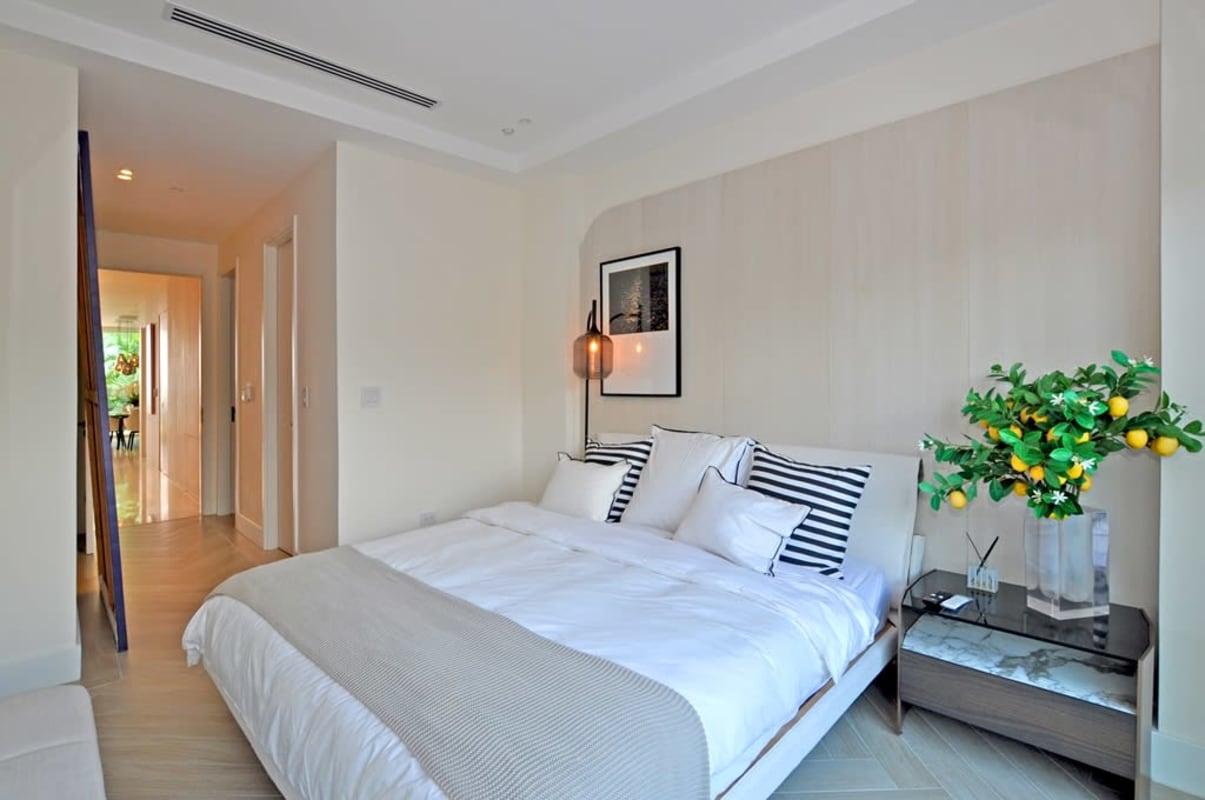 Modern master suite with built-in closets and garden views at The Beach Club Ocean Reef