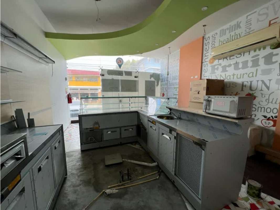 Juice bar interior with glass counter, ceiling design and mural graphics in turnkey retail space San Francisco Panama