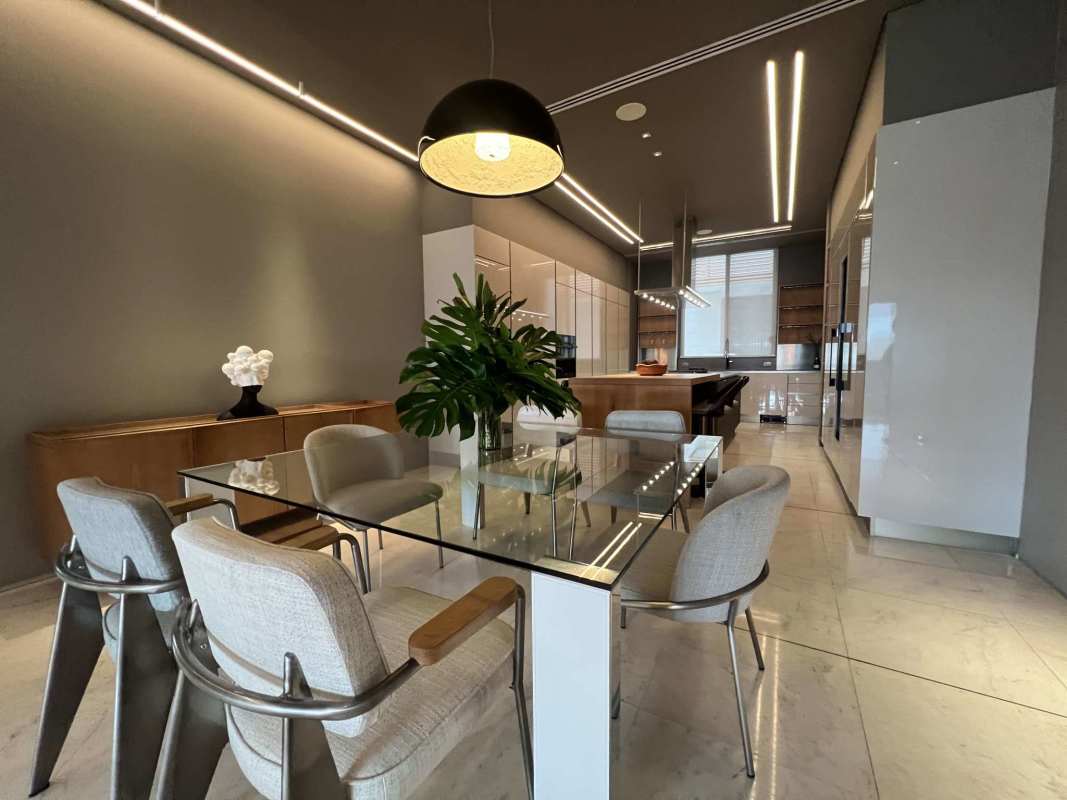 Modern open dining and kitchen area with sleek finishes in Ocean Reef Islands villa Panama