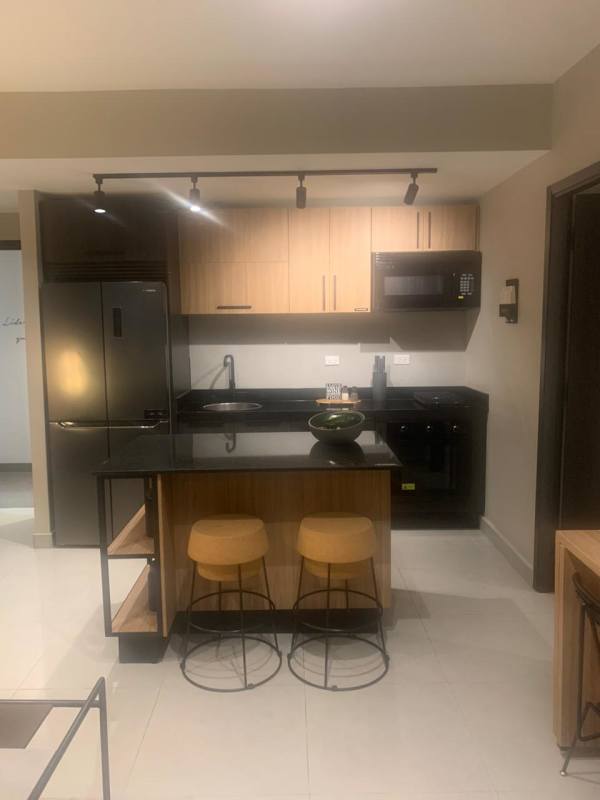 Fully equipped kitchen with island seating, stainless appliances, PH Nostrum Obarrio Panama