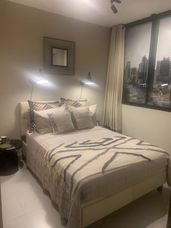 Bright bedroom with large window city skyline view at PH Nostrum Obarrio Panama City