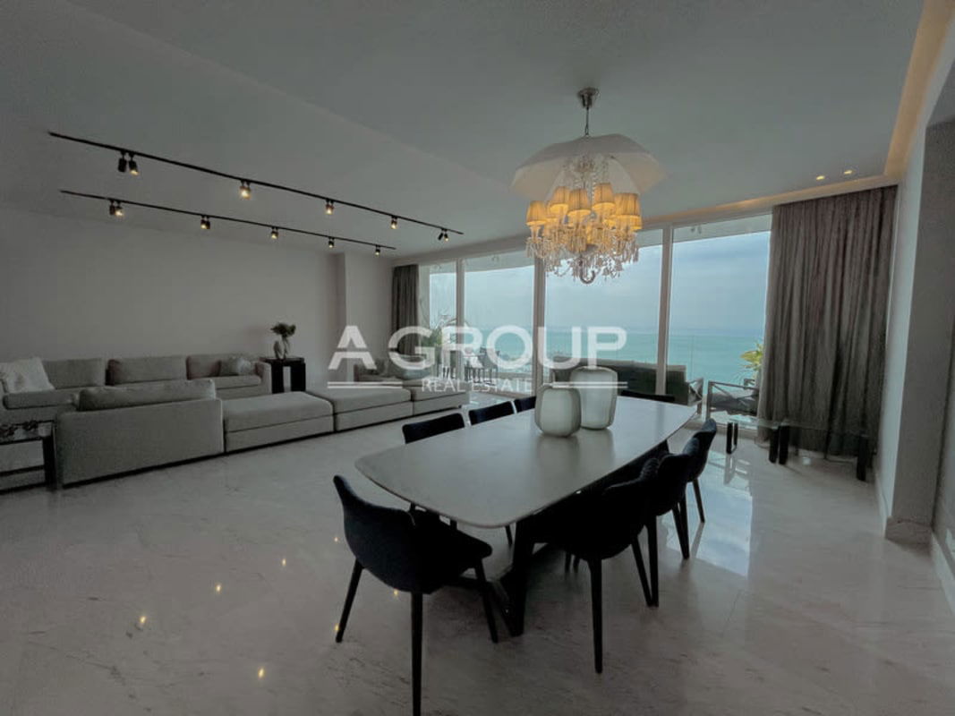 Modern living dining open space with panoramic windows overlooking Panama Bay in The Towers Punta Paitilla Panama