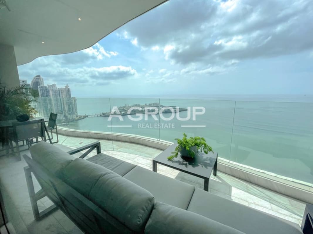 Modern balcony with outdoor seating area and unobstructed sea and skyline views in The Towers Panama City