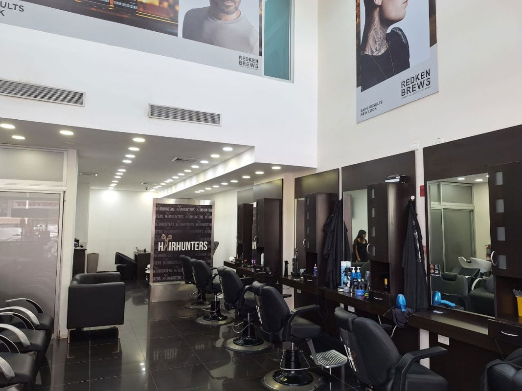 Salon interior with styling chairs, product displays and waiting area in Costa del Este Panama