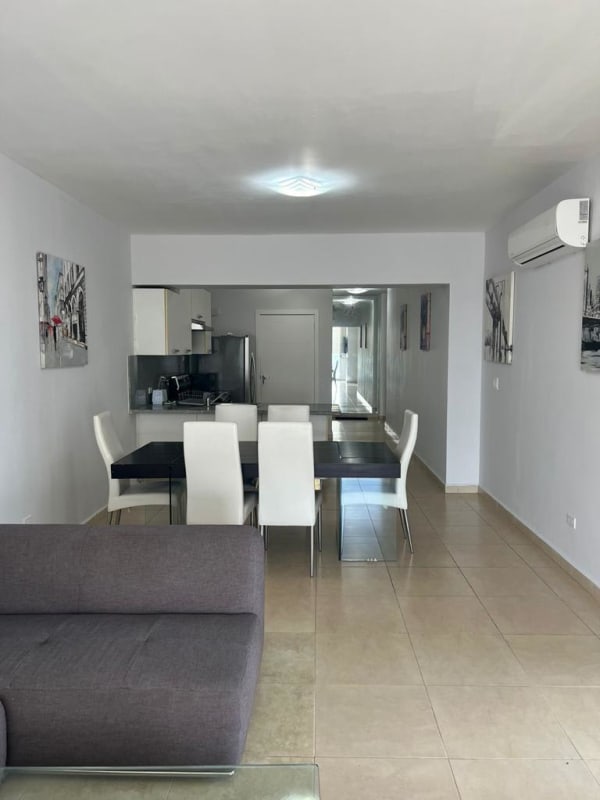 Dining space adjacent to kitchen with skyline and ocean view at PH BICSA