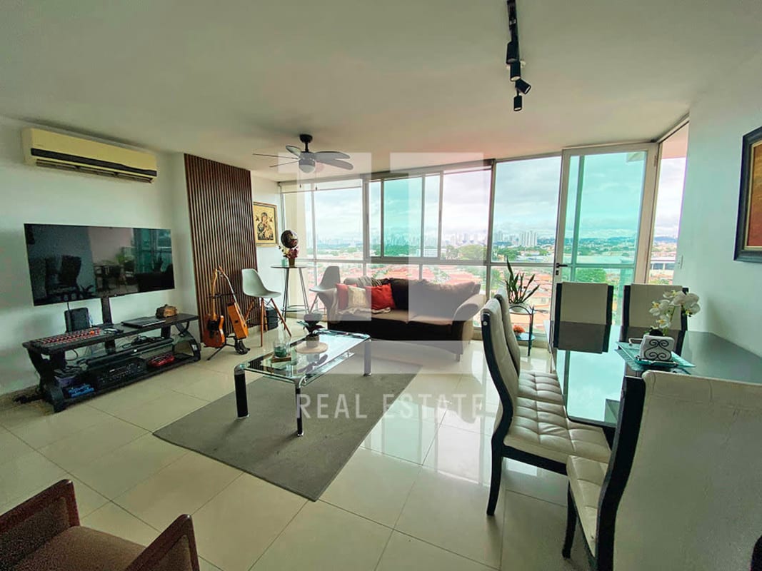 Bright bedroom with large window overlooking city at PH La Creta in Chanis Panama City