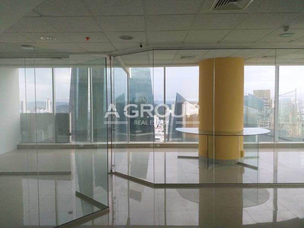 Large glass windows offering Panama City skyline views in PH F&F Tower office