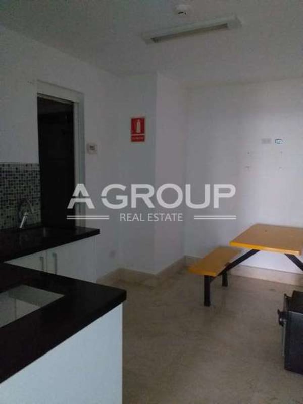 Office kitchenette with dining area granite counters mosaic tiles in twisting tower Panama