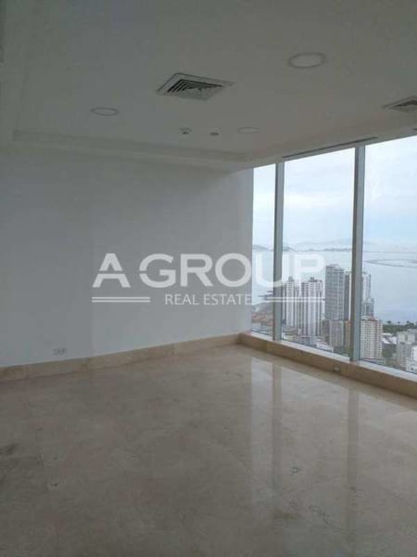 Large living/open office with marble floors panoramic windows ocean city view Panama
