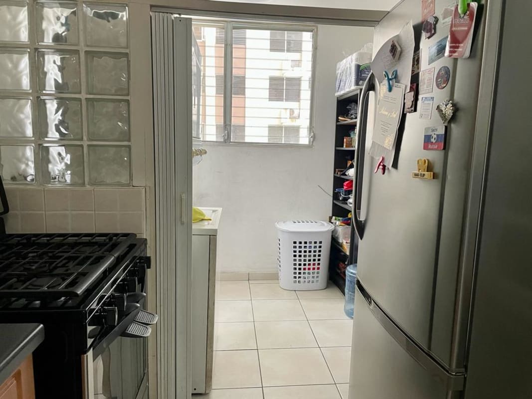 Kitchen with wood cabinets, granite countertops, gas stove and modern appliances in PH San Francisco Bay Panama