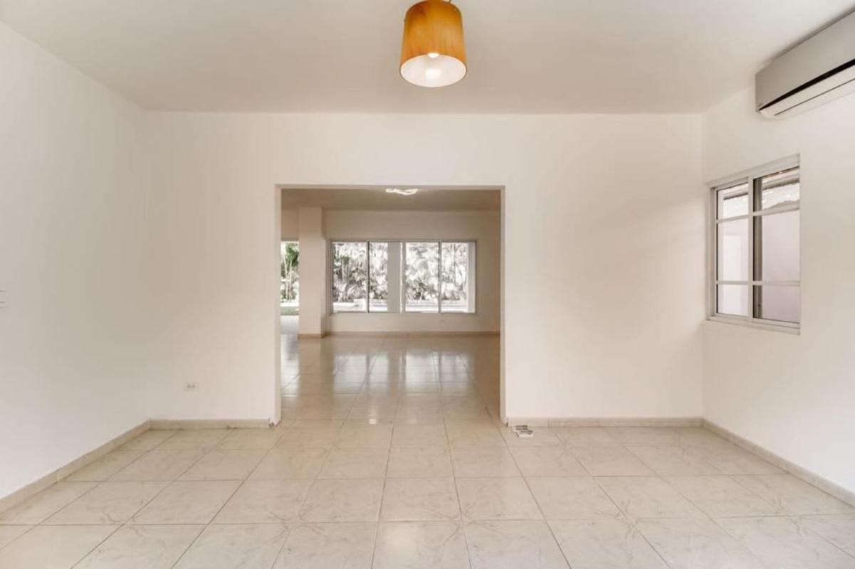 Spacious living room with natural light, tiled floor, large windows in Costa Serena Costa del Este Panama