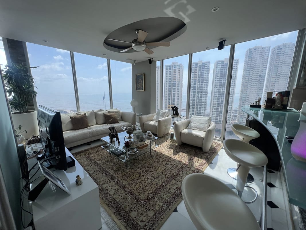 Contemporary living room with skyline views, sectional sofas, floor-to-ceiling windows at PH Prive San Francisco Panama