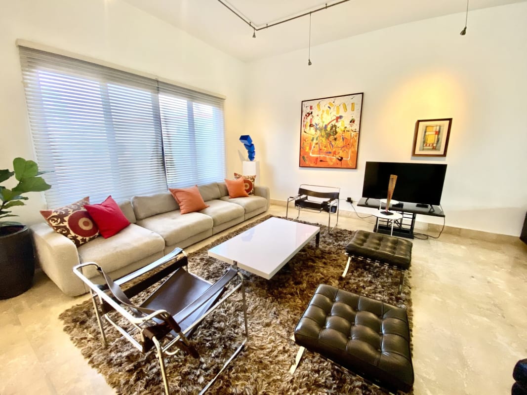 Covered outdoor terrace with garden and pool view in luxury house Costa del Este Panama