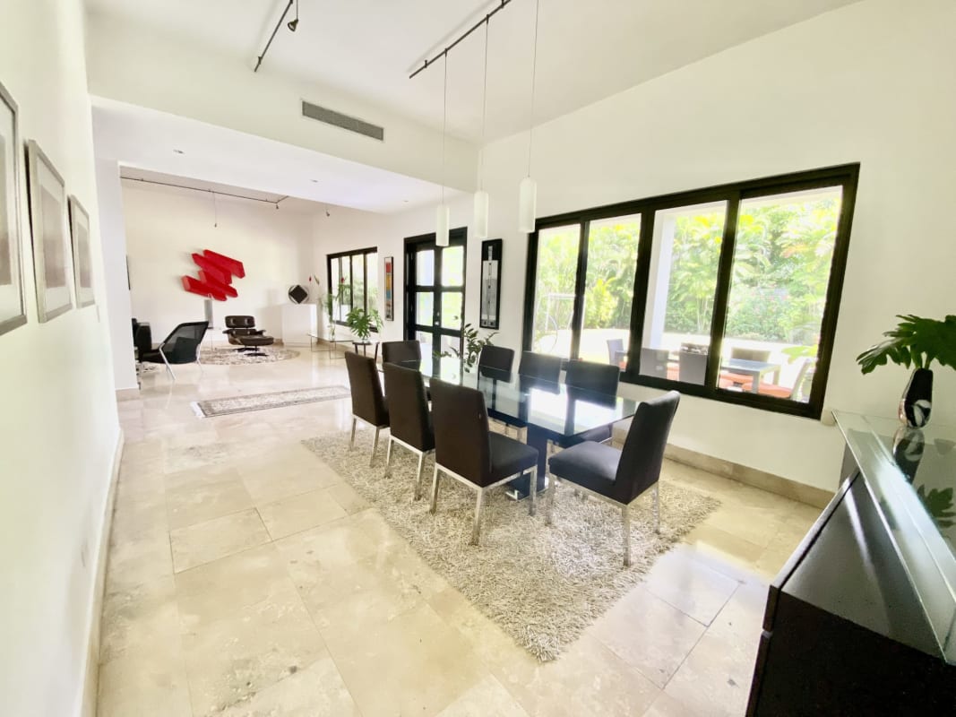 Spacious marble-floored living room with large windows and art in luxury home Costa del Este Panama