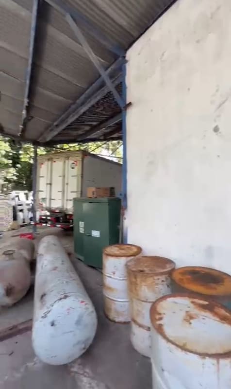 Industrial covered storage with metal roofing, barrels, tanks, and container Perejil Pedregal Panama