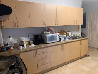 Modern kitchen with granite countertops, refrigerator, microwave, Playa Blanca beachfront rental
