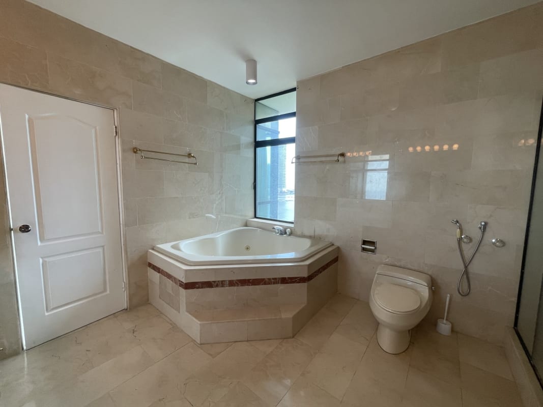 Bathroom with corner bathtub marble tiles large window PH Miramar Panama