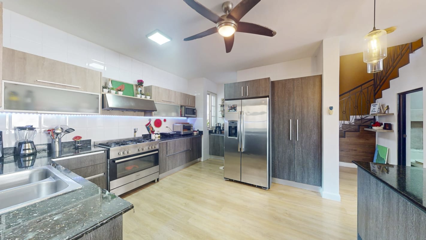 Spacious kitchen with granite counters, wood cabinets, stainless appliances PH Villa Valencia Costa Sur Panama City