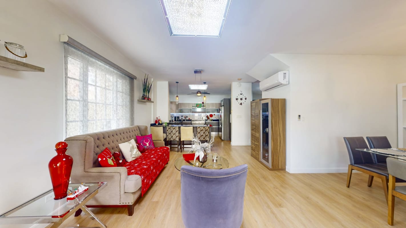 Bright open living and dining with wood floors window split AC PH Villa Valencia Costa Sur Panama
