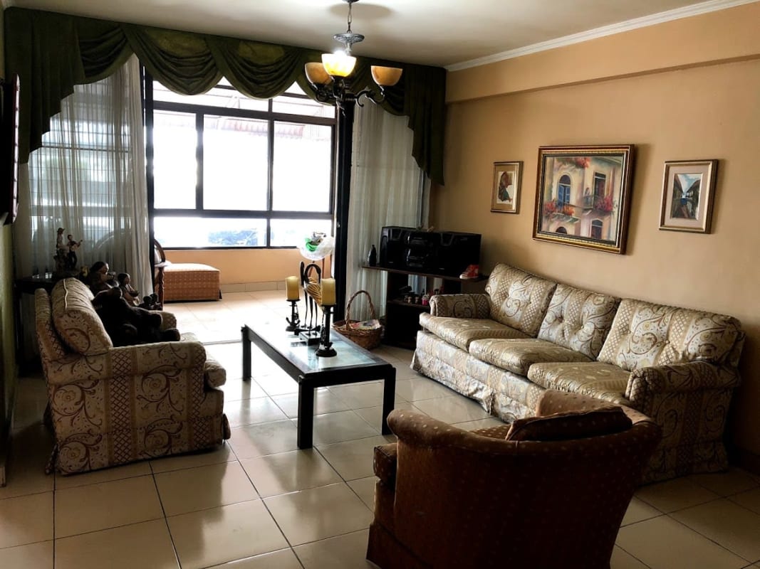Living room with large windows green curtains tile flooring in PH Los Mellizos Panama