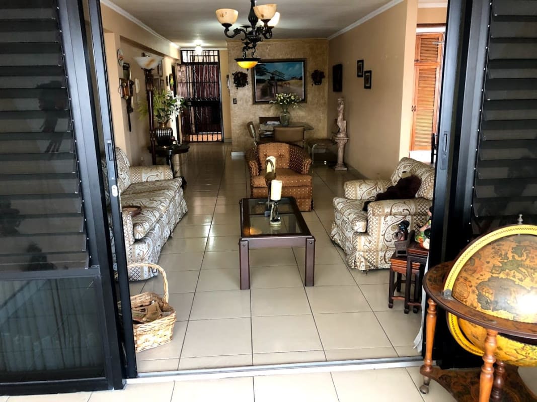 Living space with large sliding doors patterned sofas PH Los Mellizos Panama