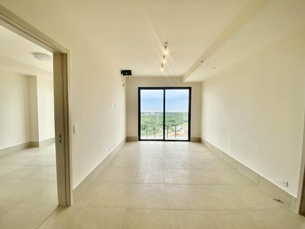 Bedroom with sliding glass doors to balcony at Ocean House Santa María Panama