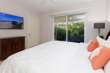 Spacious master bedroom with balcony access, nature views in Puntaarena Ocean Village Panama