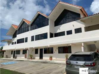 Mediterranean style exterior with red-tile roof and large windows in Brisas de Coronado gated community