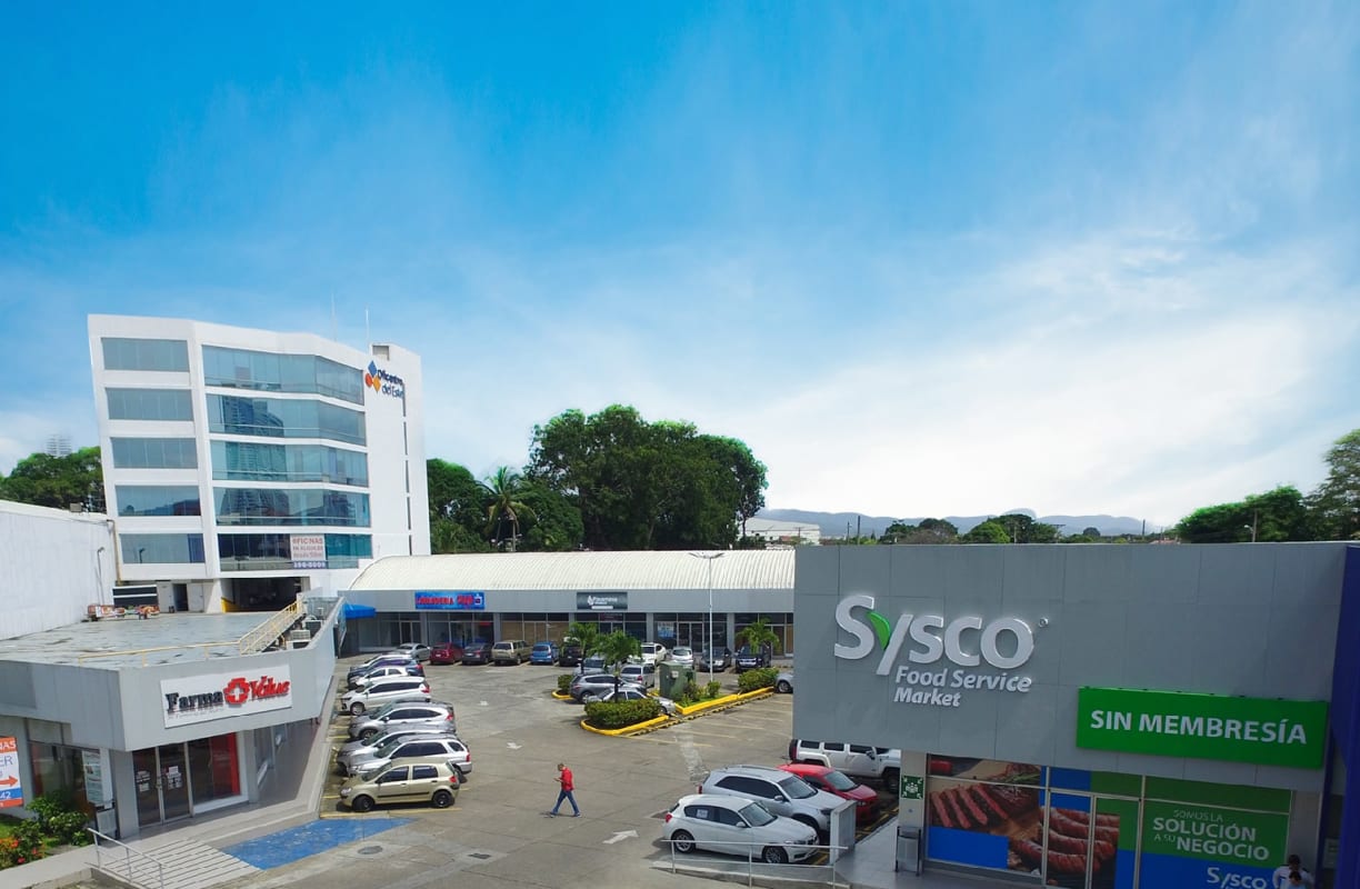 Ground level view of parking lot and retail storefronts Centro del Este Plaza in Costa del Este Panama