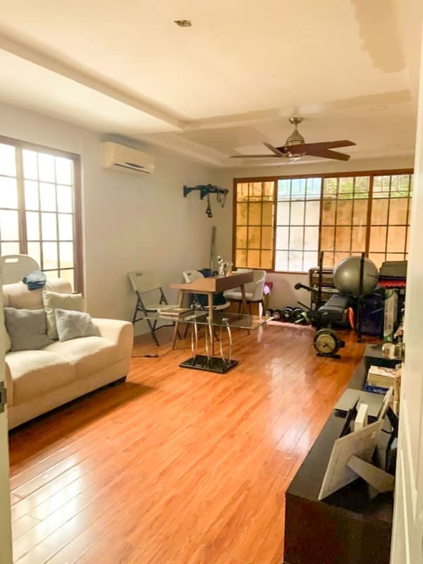 Covered terrace patio with hammock, ceiling fan, seating and plants in San Antonio Panama house