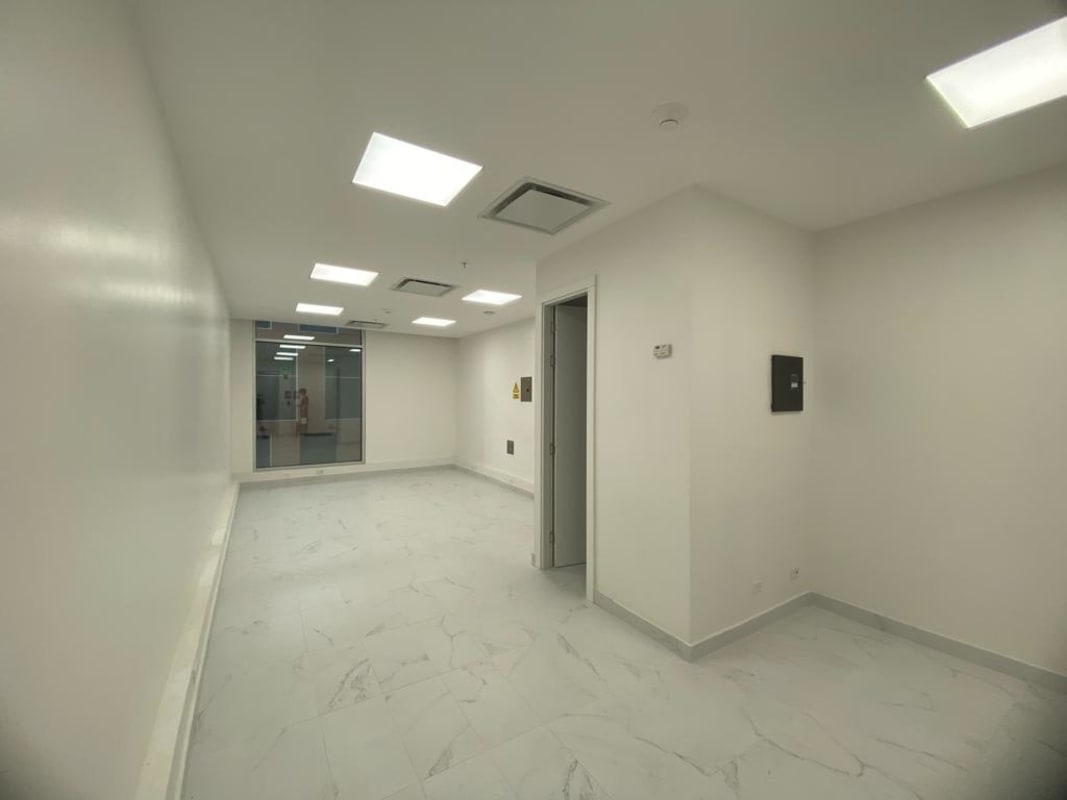 Empty modern office with white walls, marble tile floor, recessed lights at TownCenter Costa del Este