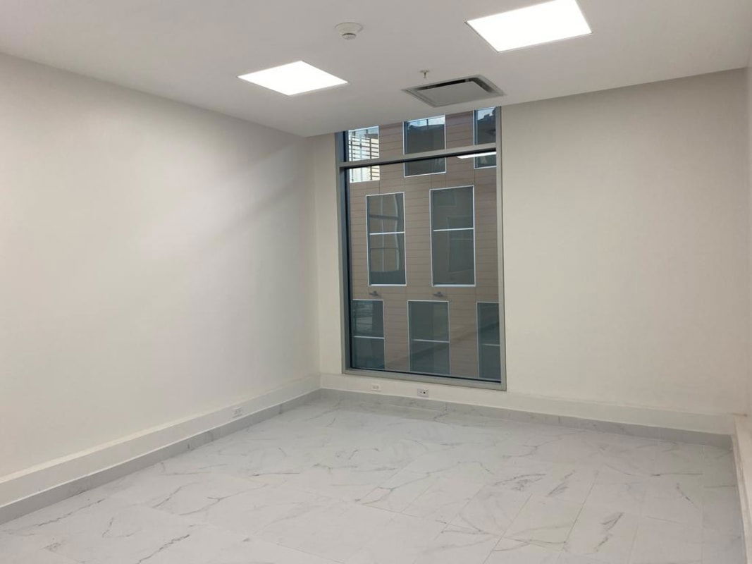 Hallway corridor with white walls, emergency signs, smoke detectors, marble tile floor in TownCenter Costa del Este