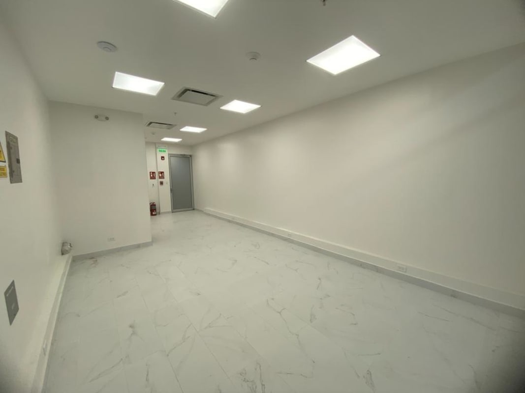 Clean bright commercial hallway corridor with marble floor and exit signage at TownCenter Costa del Este Panama