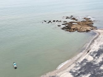 Bright living dining area with split AC, ceiling fan, TV, panoramic window beachfront condo in Panama