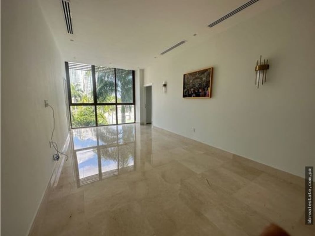 Large empty living space with marble floors at PH Garden Apartments, Ocean Reef Islands