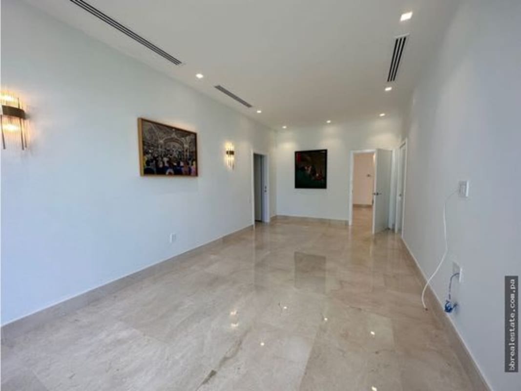 Spacious contemporary living area with recessed lighting marble flooring at PH Garden Apartments