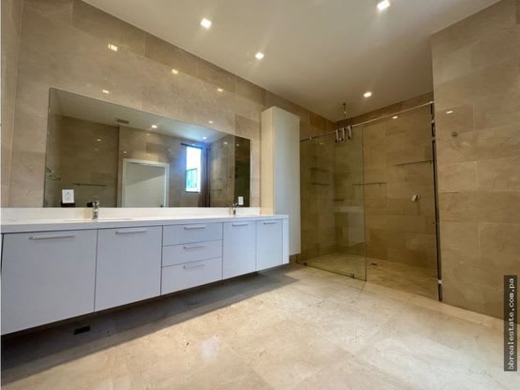 Elegant ensuite bathroom with glass shower and double vanity at PH Garden Apartments Ocean Reef Panama