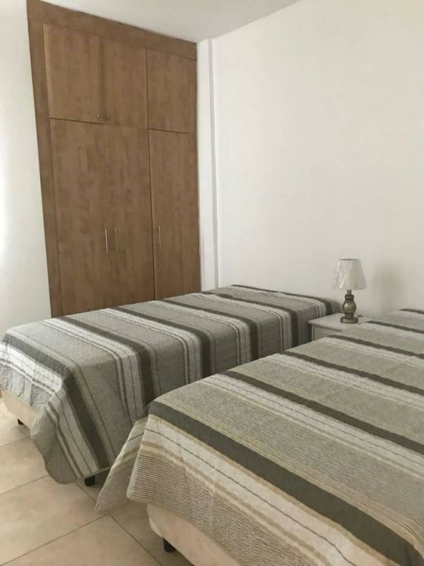 Spacious bedroom with large wardrobe and tiled floor in PH ParkView San Francisco Panama