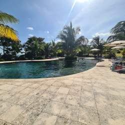 Large tropical swimming pool with palm trees in PH Ensenada Coronado Panama