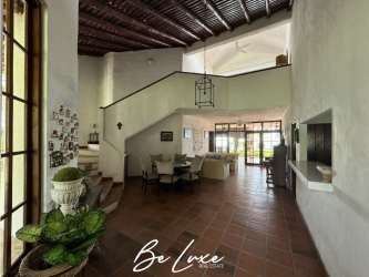 Bright Mediterranean bedroom with rustic tiles queen bed AC ceiling fan El Chiru Panama