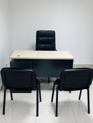 Minimalist private office with desk chair and guest chairs inside Hospital Chiriquí Tower David Panama