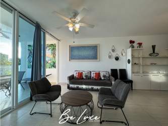 Kitchen with black granite counter, appliances, tile backsplash Playa Blanca condo